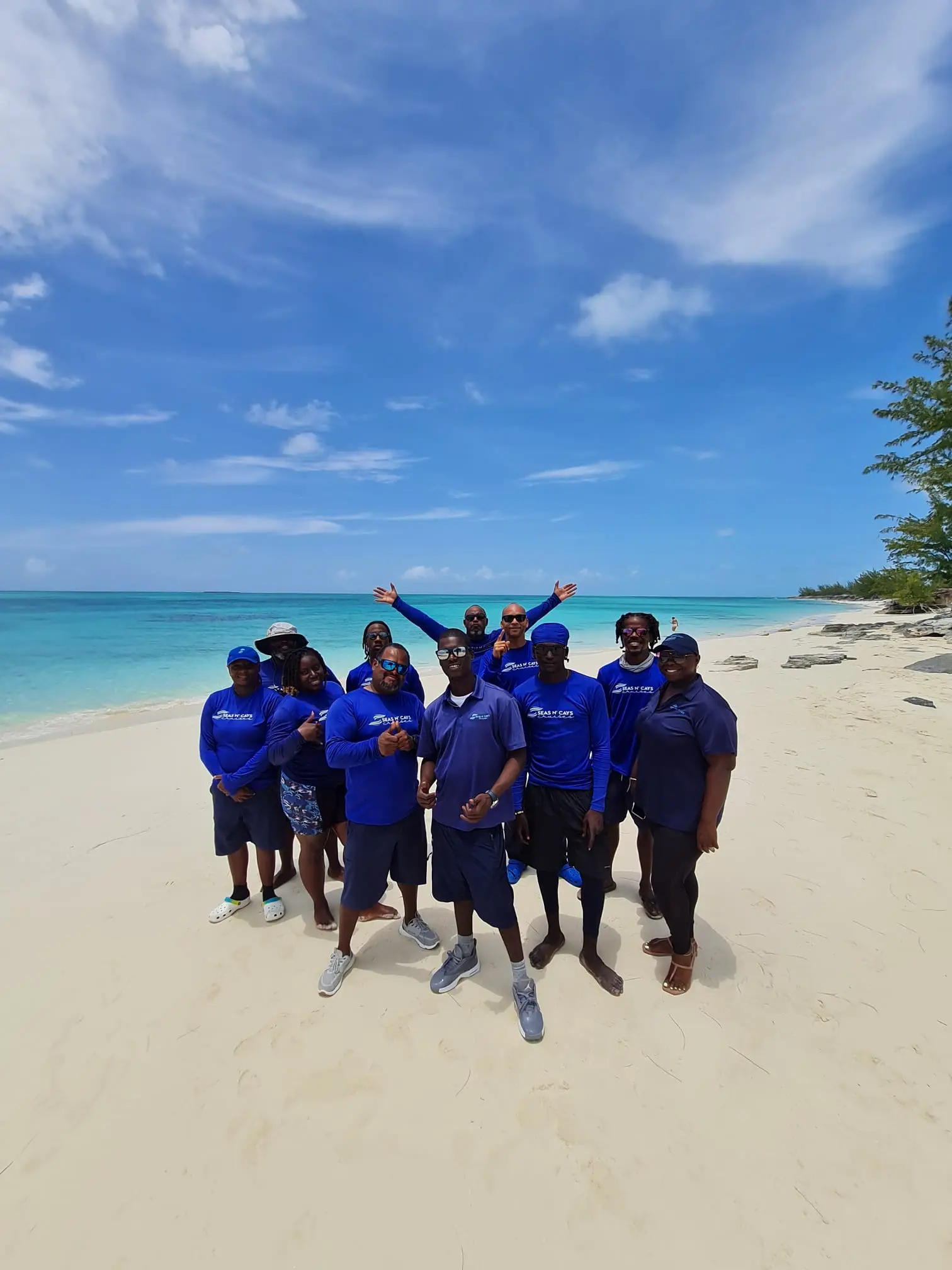 The Seas N' Cays crew gathered on the beach at Rose Island